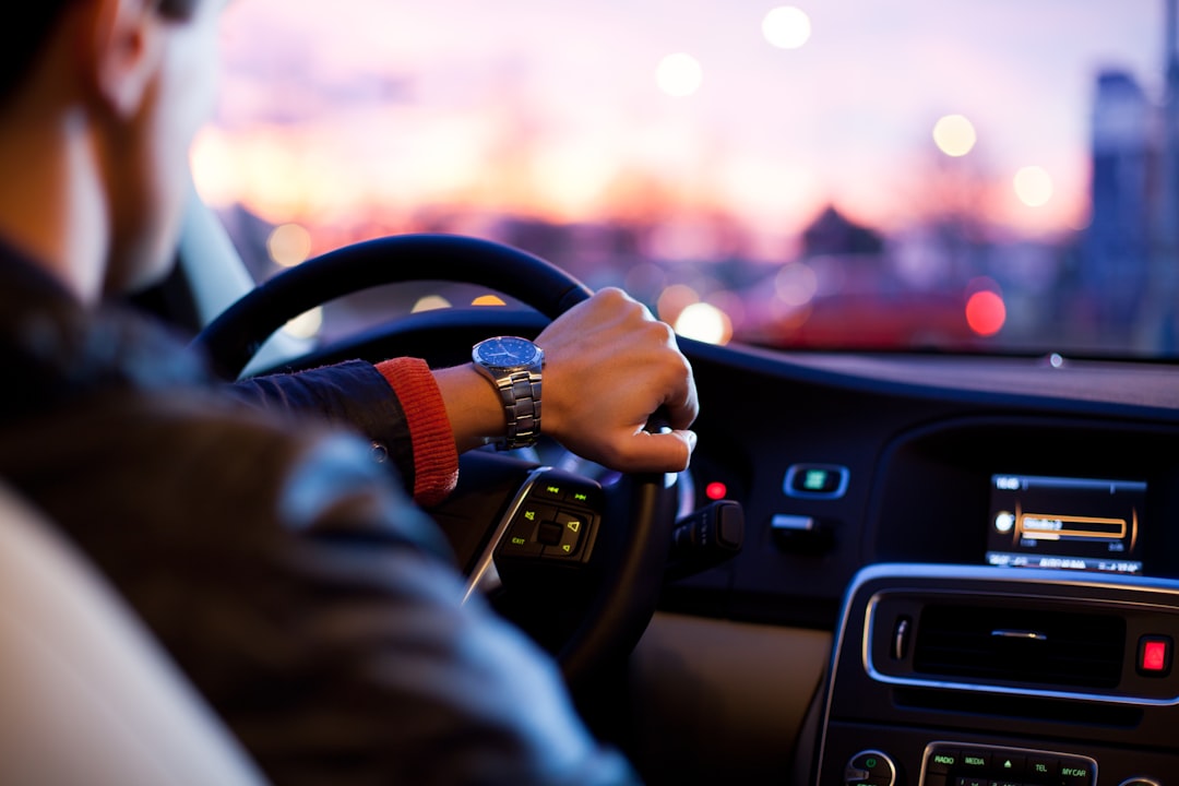 A driver behind the wheel at dusk